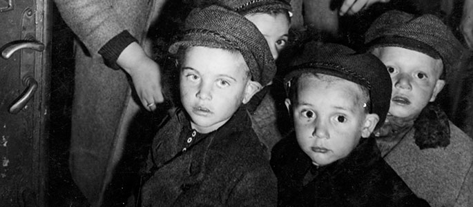 Child survivors of the Holocaust with their chaperone, in Czechoslovakia, about to board a train bound for Western Europe