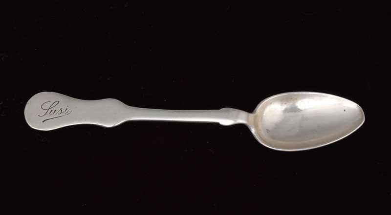Small silver teaspoon engraved with the name of a girl, Suzy Strauss