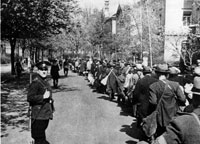 April 1942, Jews being led through the streets of Würzburg by German policemen, en route to the train station.