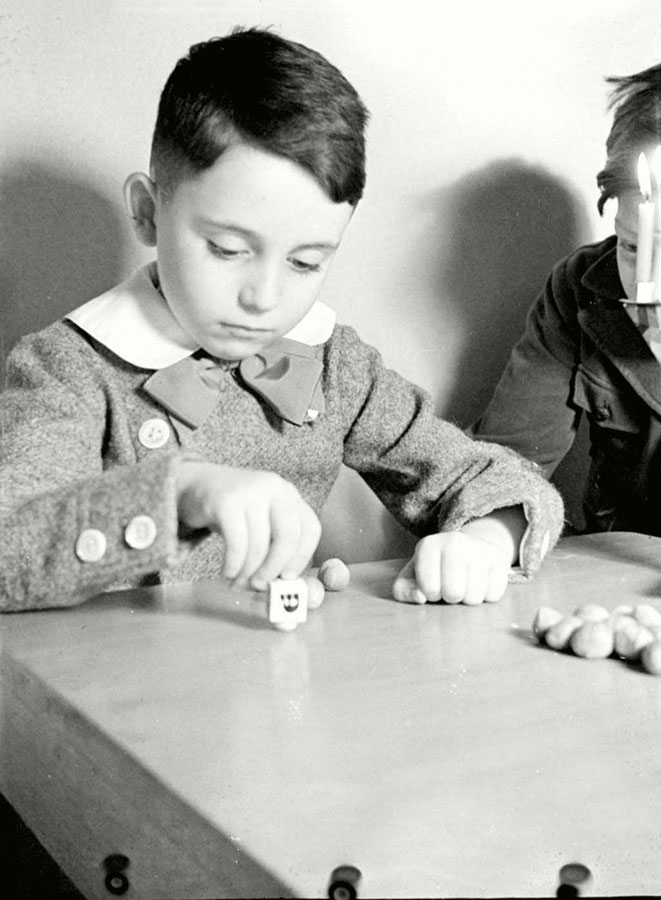 Berlin, Germany, Hanukkah 1930s, a boy playing with a dreidel
