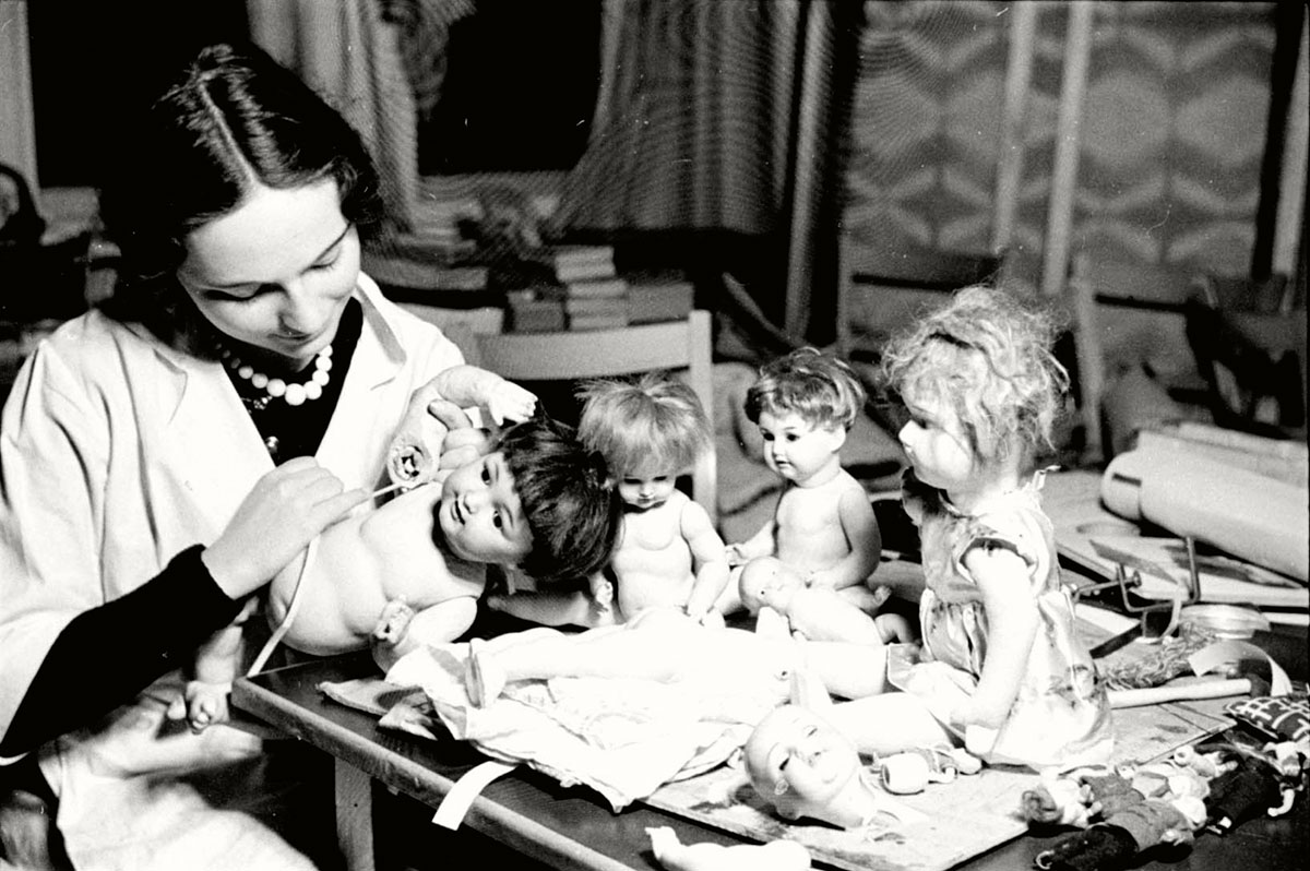 Berlin, Germany, 1936, A girl mending toys to be given to needy children on Hanukkah. A training college for kindergarten teachers and nurses in children's' homes, Meinekestrasse 22