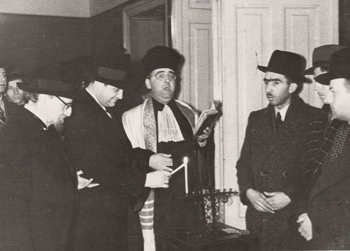 Bucharest, Romania, 1942, lighting of the Hanukkah candelabrum. Dr. Beck, Hapheral and Ruwuski are present in the photograph