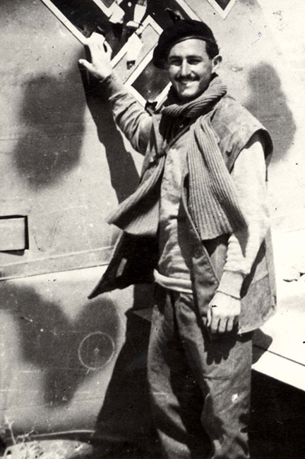 Marius Garb standing beside a downed German plane