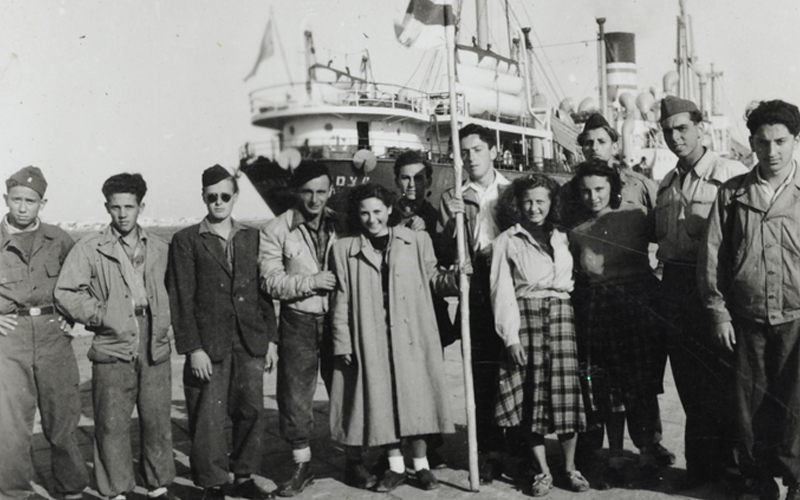 Agnes Rosenfeld (wearing a light blouse and a checked skirt) before her immigration to Eretz Israel (Mandatory Palestine) with fellow members of the Maccabi Hatzair movement, 1949.