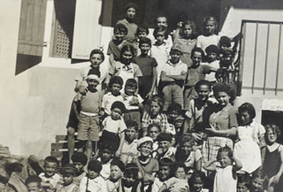 Staff and children on the steps of the Saint Paul children’s home, 1943