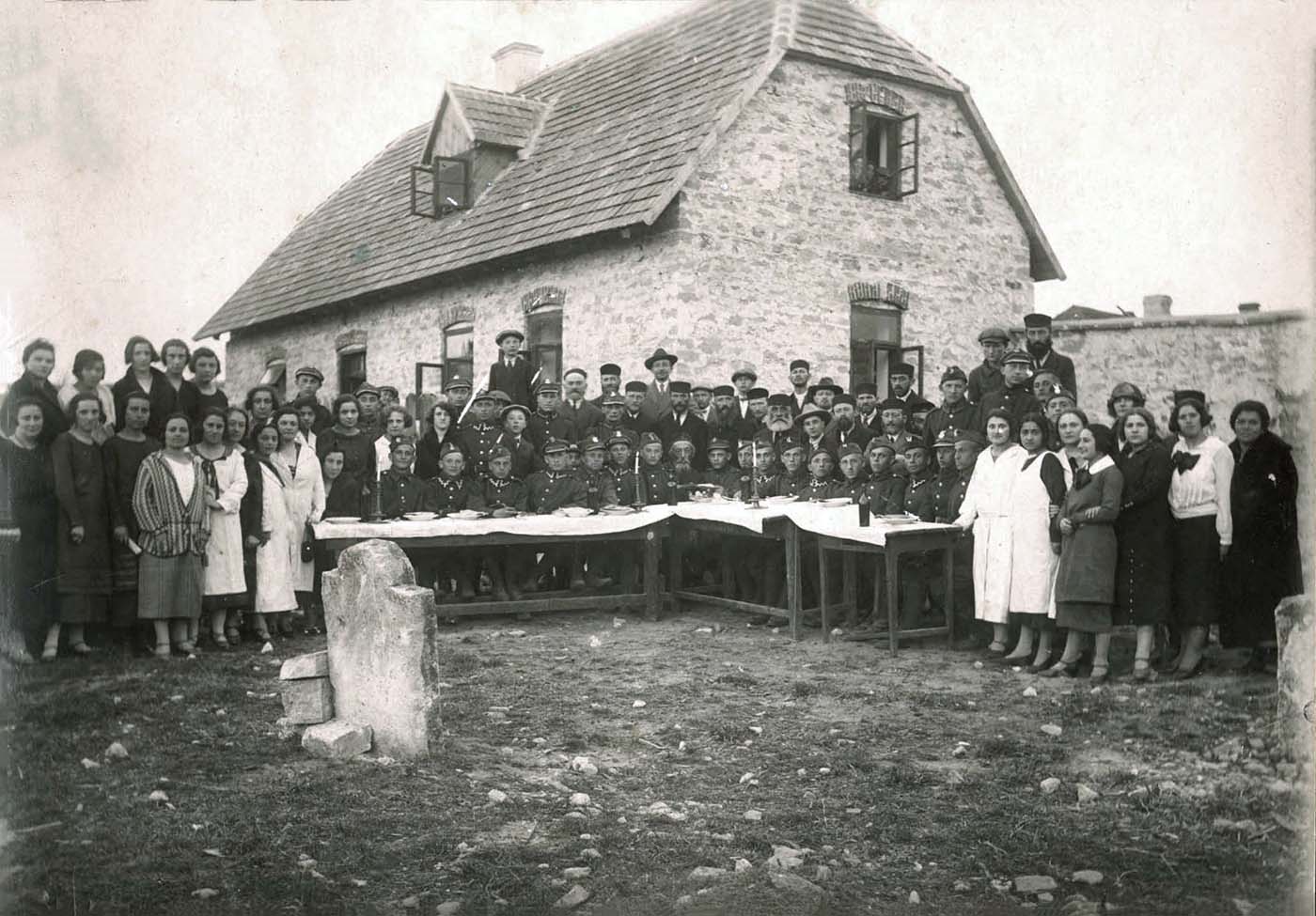 A group photo of Jewish soldiers and community members at a Passover Seder arranged by the community, Staszow, Poland,  prewar