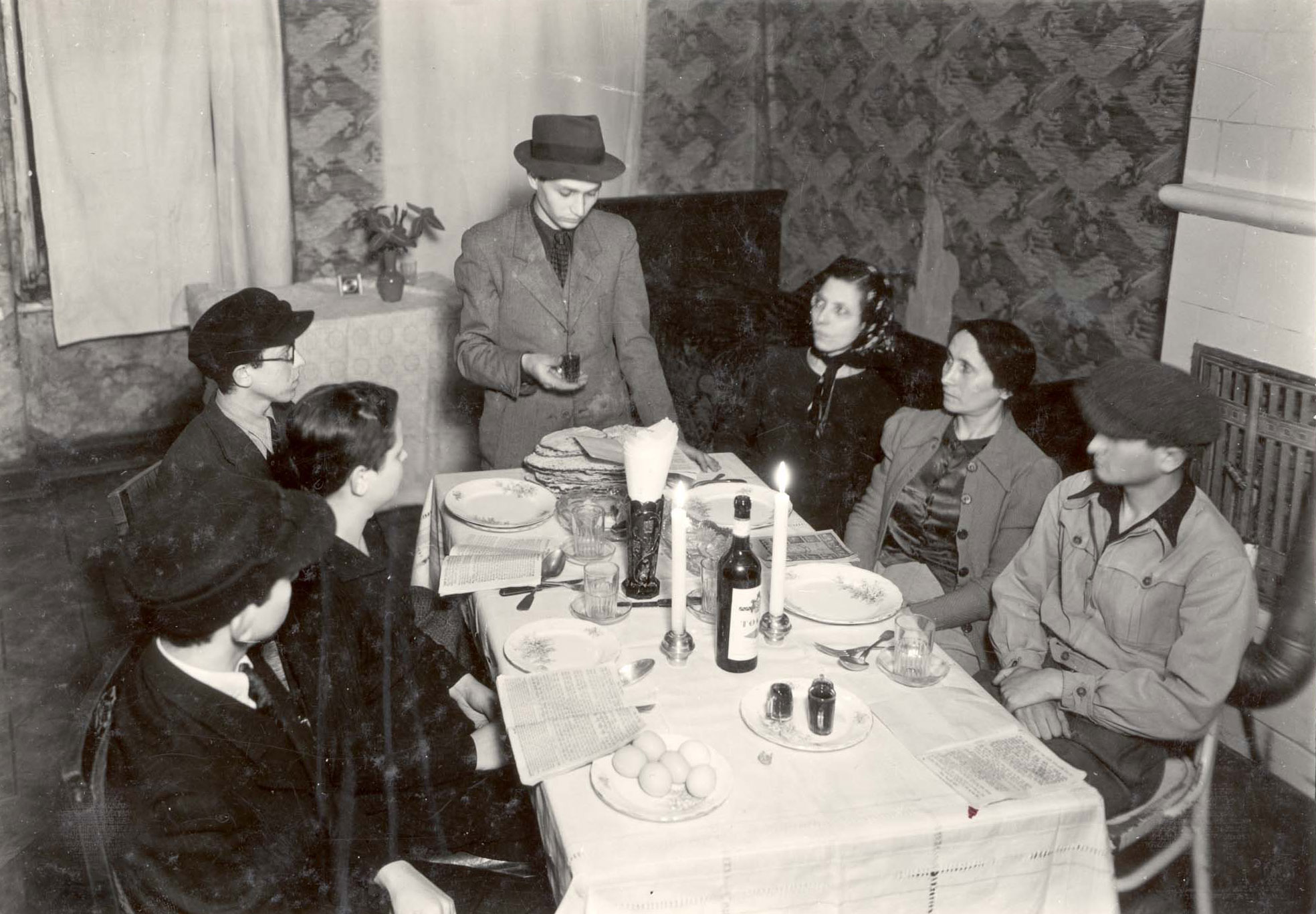 A man reciting a blessing over a cup of wine at a Passover Seder in the Warsaw Ghetto, Poland