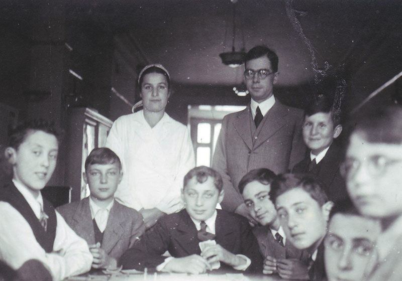 Fritz Penas (later Frederick Marchand) and his fellow pupils at the "Yavne" Jewish gymnasium in Köln, Germany, together with their teacher, Dr. Zeligson and his wife at the hostel where they stayed in London, 1939.  Fritz is standing on Dr. Zeligson's left