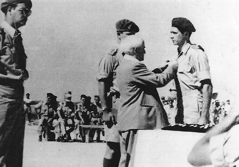 Prime Minister David Ben Gurion pinning the winged parachute badge on Shimon Tsachor-Weiss, October 1949 