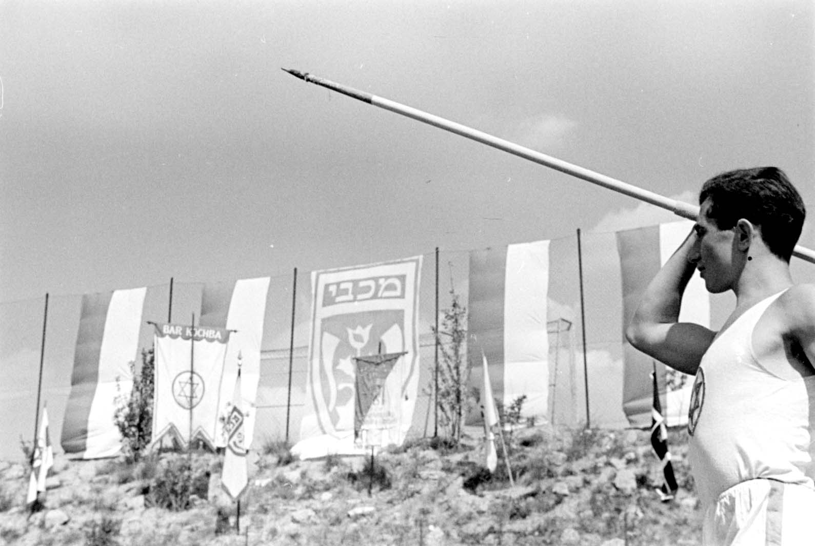Berlín, Alemania, preguerra. Evento deportivo: jabalina. En el trasfondo se ven varias banderas, entre ellas las de las asociaciones deportivas "Macabi" y "Bar Kojba"