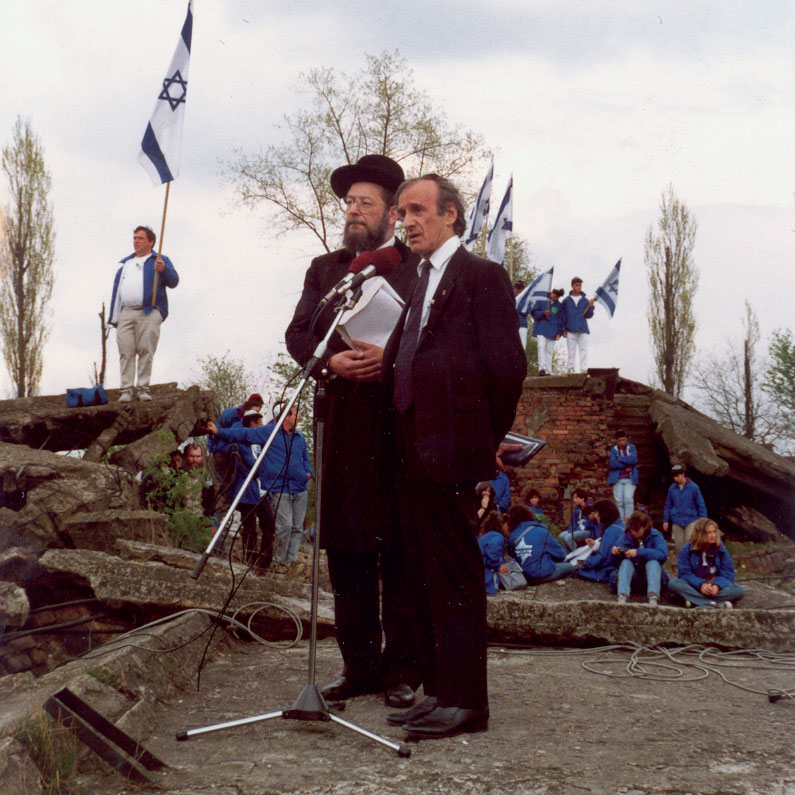Participating in the first March of the Living in Auschwitz-Birkenau on Holocaust Remembrance Day 1988, with fellow Buchenwald survivor and Nobel Peace Prize Laureate Elie Wiesel, at the ruins of a destroyed crematorium