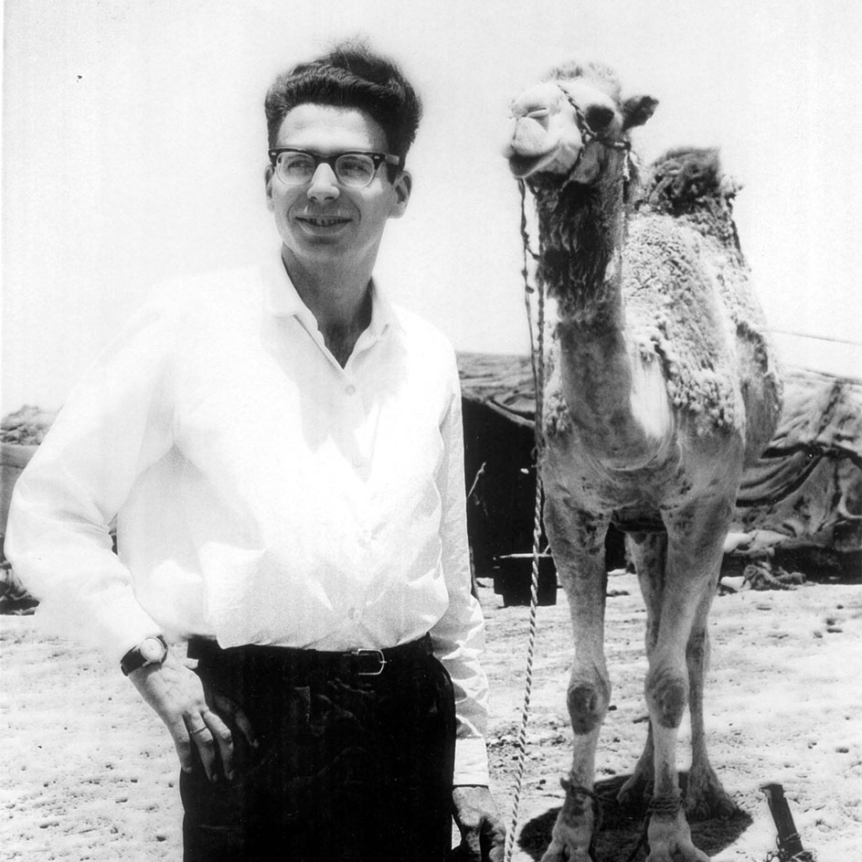 Kalman posing with a camel that was part of an analogous study on the ability of various animals and human beings to adapt to hot and dry climates