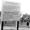 Sign at the ghetto entrance warning against "Danger of Epidemics: Jewish Settlement Zone." The text includes details of the penalties for entering or leaving the ghetto without permission. Radom, Poland.