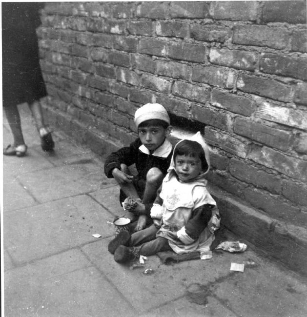 Poland ,Warsaw, ילדים יושבים על רצפת הרחוב ומקבצים נדבות.<br>
ארכיון יד ושם, 2536/73