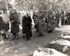 Людвигслуст, Германия, 07/05/1945. Местные жители проходят мимо трупов заключенных лагеря.